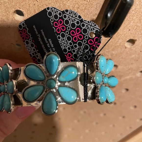 Silver cuff bracelet with three turquoise crackle flowers.